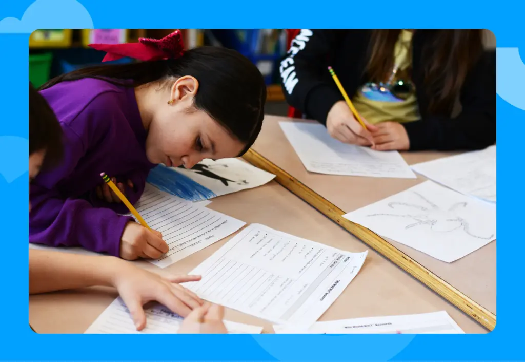 Students doing writing worksheet at their desks.