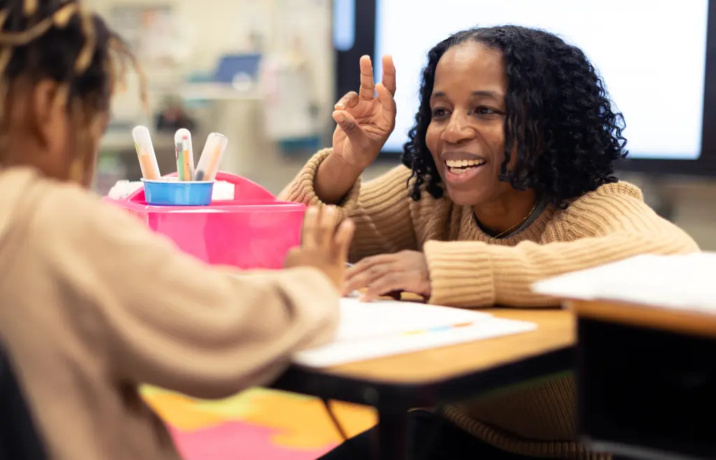 Teacher Dr. Carla Miller tapping with a student