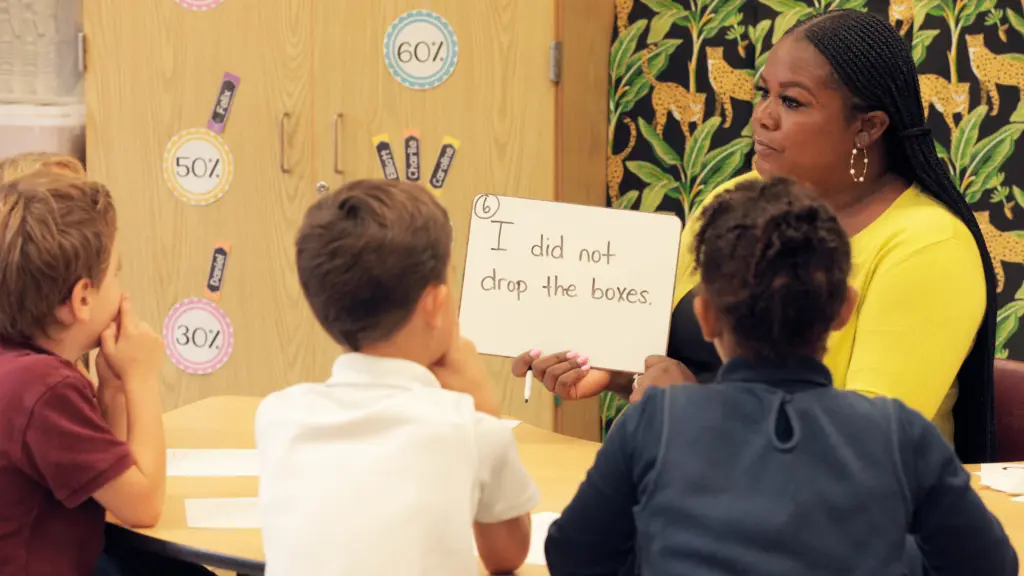 Small group grammar lesson with whiteboard.