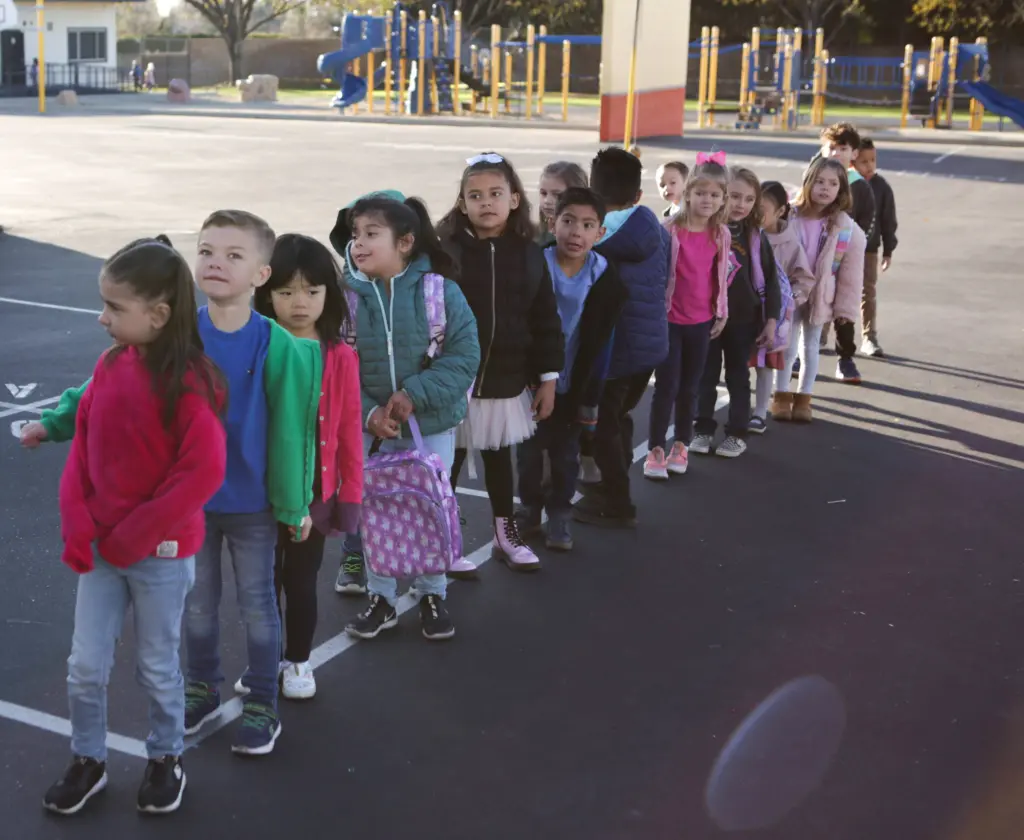 Students standing in a line outside.